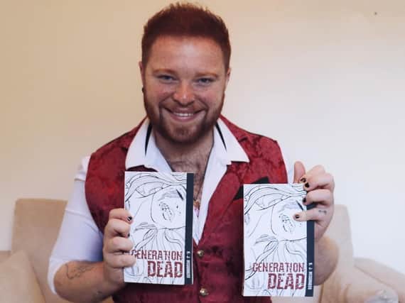Kier McGuinness with copies of his book Generation Dead.