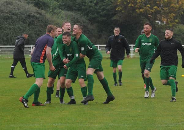 James King of Hunslet Club is mobbed after scoring the winning penalty in his side's 7-6 shootout victory over Beeston St Anthony's. PIcture: Steve Riding.
