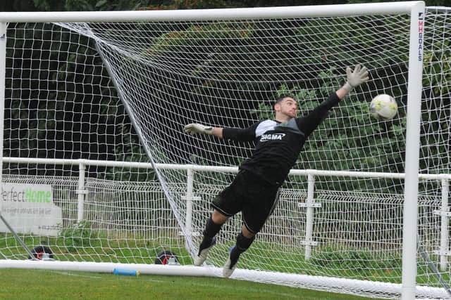 Beeston St Anthony's goalkeeper Steve Kerr dives in vain to keep out 
Matthew Pallister's shot. 
Picture: Steve Riding.