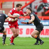 George Lawler is tackled by Grant Millington, left and Cheyse Blair during Hull KR's Challenge Cup loss to Tigers in April. Picture by Alex Whitehead/SWpix.com.