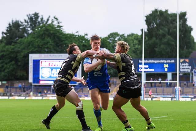 BRIGHT FUTURE: Leeds' Morgan Gannon is tackled by Leigh's Joe Mellor and Junior Sa'u. Picture by Alex Whitehead/SWpix.com