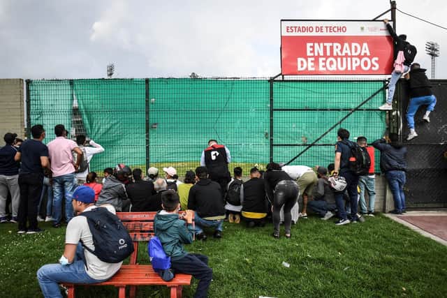 CLAMOUR: Fans try to get a peep of the Brazil squad training at their closed-door session at Techo stadium, in Bogota, Colombia on Tuesday ahead of the World Cup qualifier against Venezuela. Photo by JUAN BARRETO/AFP via Getty Images.