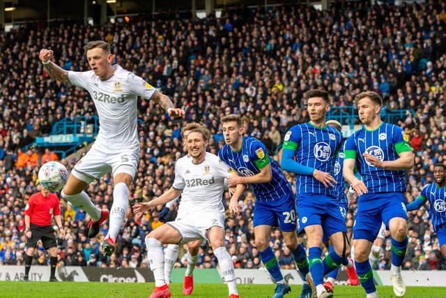 MEMORIES: Ben White, right, rises for a header at a corner during Leeds United's clash against Wigan Athletic at a packed Elland Road of February 2020. Picture by Bruce Rollinson.