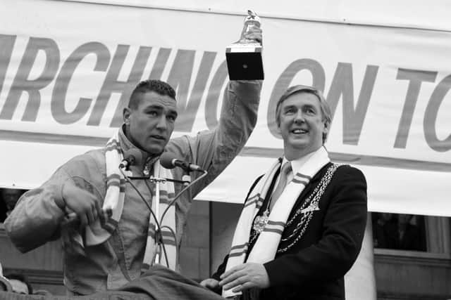 Vinnie Jones raises aloft the Division 2 championship trophy during a civic reception in May 1990. PIC: Gary Longbottom