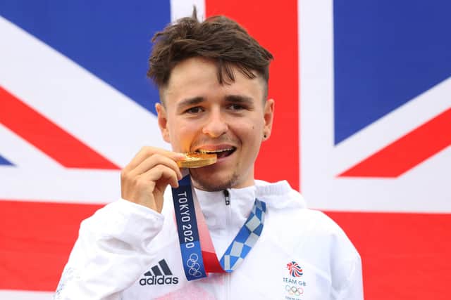 Present and future: Tom Pidcock of Team Great Britain bite his gold medal and pose with the flag of his country in the background after the Men's Cross-country race on day three of the Tokyo 2020 Olympic Games at Izu Mountain Bike Course on July 26, 2021 in Izu, Shizuoka, Japan. (Picture: Michael Steele/Getty Images)