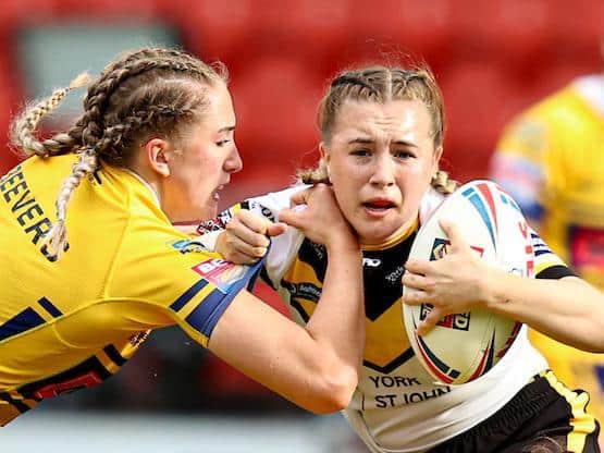 Caitlin Beevers, left, tackles York's Georgie Hetherington during Rhinos' semi-final win. Picture by Paul Currie/SWpix.com.