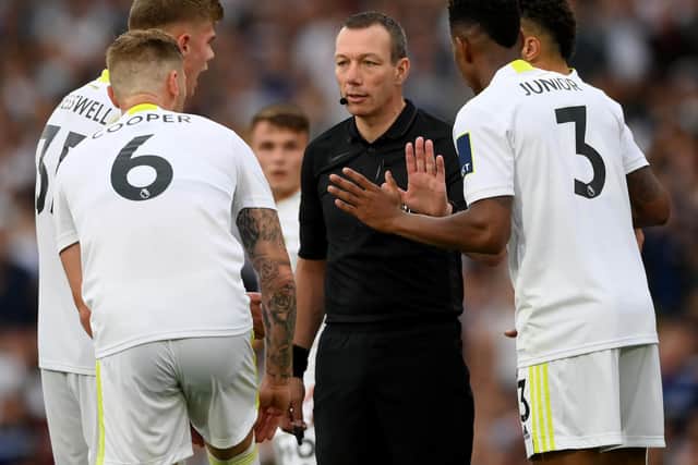 Leeds United surround referee Kevin Friend amid a VAR review at Elland Road. Pic: Getty