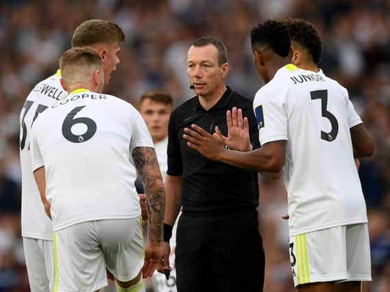 Leeds United surround referee Kevin Friend amid a VAR review at Elland Road. Pic: Getty