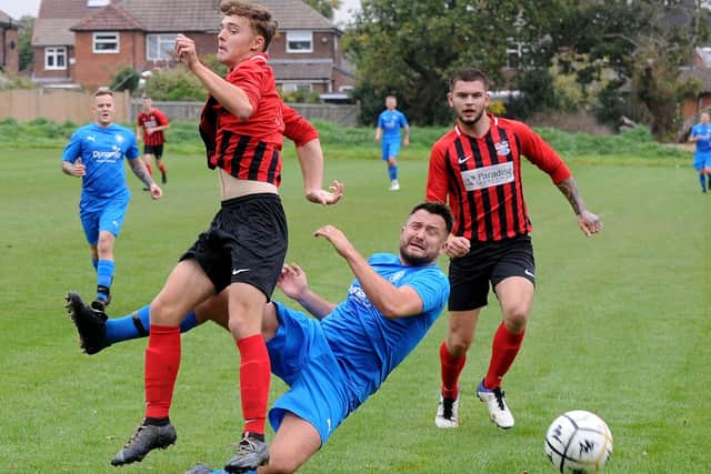 Alwoodley's Adam Turner shoots past Sam Brearley, of Lower Hopton, during Saturday's Yorkshire Amateur League Supreme division encounter. Picture: Steve Riding.