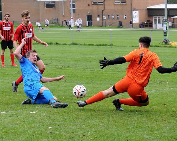 James Turner, of Alwoodley, scores past Lower Hopton goalkeeper Kieran Holmes during Saturday's Yorkshire Amateur League Supreme Division encounter. Picture: Steve Riding.