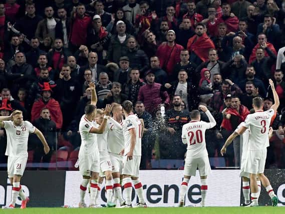 Poland's players are hit by missiles after opening the scoring against Albania. Pic: Getty