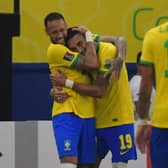Leeds United's Raphinha is embraced by Neymar after scoring for Brazil. (Photo by NELSON ALMEIDA/AFP via Getty Images)