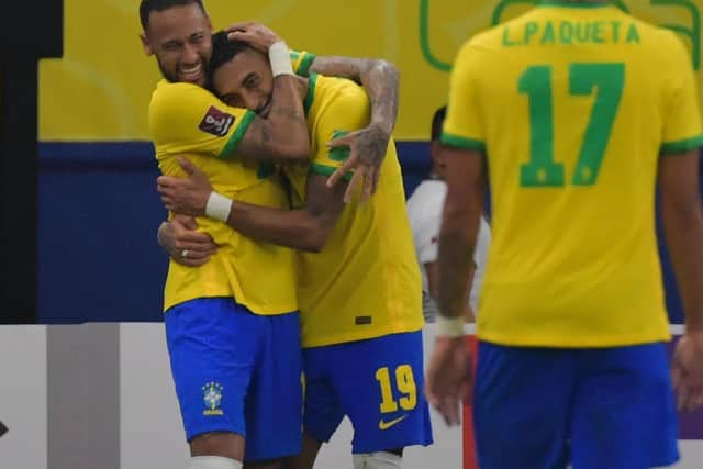 Leeds United's Raphinha is embraced by Neymar after scoring for Brazil. (Photo by NELSON ALMEIDA/AFP via Getty Images)