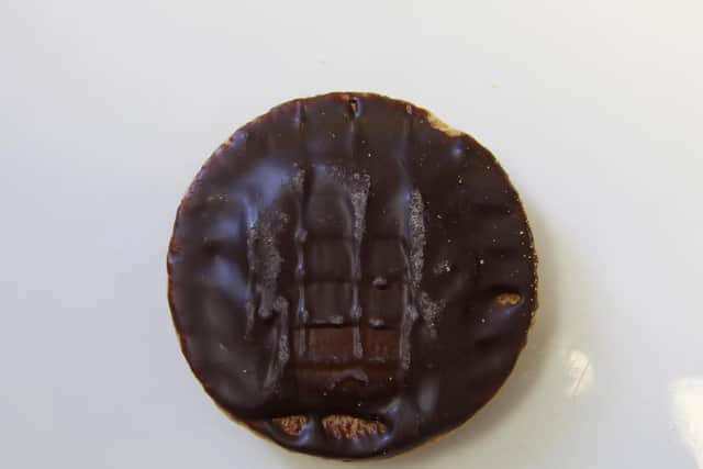 A police officer has been sacked after taking two packets of Jaffa Cakes from a station tuck shop without paying full price.