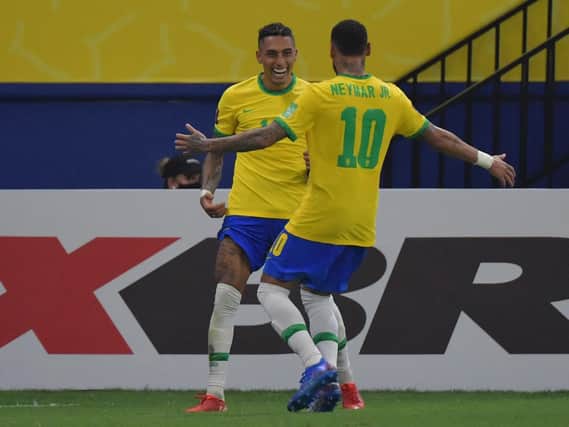 DYNAMIC DUO: Leeds United winger Raphinha, left, celebrates with Brazil team mate Neymar after netting in Friday's World Cup Qualifier against Uruguay in Manaus. Photo by NELSON ALMEIDA/AFP via Getty Images.