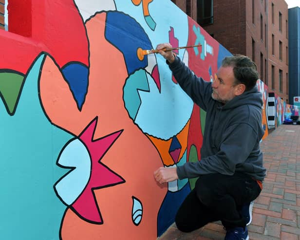 Nicolas Dixon working on a massive 130ft mural, which is one of the longest, if not the longest, single artworks in Leeds
PIC: Jonathan Gawthorpe