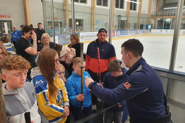Leeds Knights forward Kieran Brown signs autographs for fans after the 5-2 win over Bees IHC at Elland Road.
