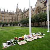 Floral tributes laid inside the gates at the Houses of Parliament in Westminster, London, following the death of Conservative MP Sir David Amess (Stefan Rousseau/PA Wire)