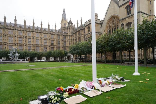 Floral tributes laid inside the gates at the Houses of Parliament in Westminster, London, following the death of Conservative MP Sir David Amess (Stefan Rousseau/PA Wire)