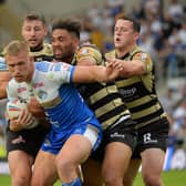 Leeds Rhinos' Mikolaj Oledzki is held by Leigh's defence.  Picture: Jonathan Gawthorpe