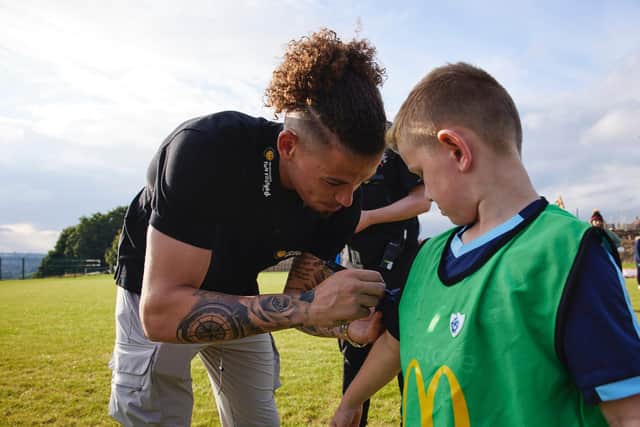 Leeds United star Kalvin Phillips hands out Blue Peter badges at his boyhood club. Pic: McDonalds.