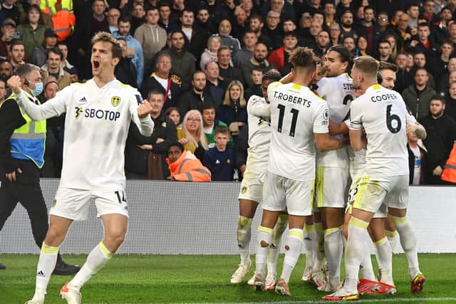 Llorente, left, shows his emotion as Rodrigo celebrates scoring Leeds' equaliser from the penalty spot. 
Picture: Bruce Rollinson.