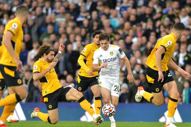 SURROUNDED: Leeds United's Dan James looks to press on as Ruben Neves leads the Wolves bid to thwart his advances. Picture by Bruce Rollinson.