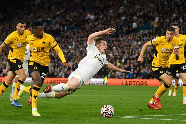 SPECIAL TALENT: Nineteen-year-old Leeds United forward Joe Gelhardt is knocked down by Nelson Semedo to win the Whites a late penalty in Saturday's clash against Wolves at Elland Road. Photo by OLI SCARFF/AFP via Getty Images.