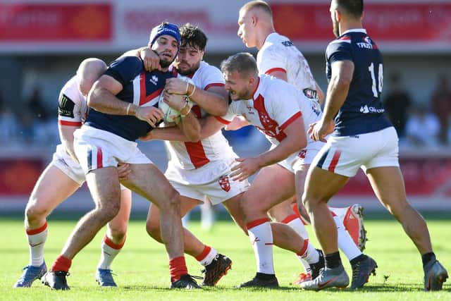 Benjamin Jullien of France is tackled by Liam Farrell (L), Joe Philbin (centre) and Jordan Abdull of England (Picture: Will Palmer/SWpix.com)