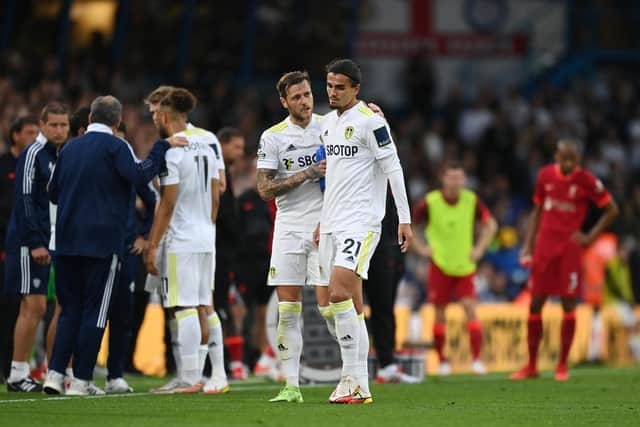 LONG WALK - Leeds United captain Liam Cooper consoling Pascal Struijk after the defender was red carded for a challenge that left Liverpool's Harvey Elliott with a dislocated ankle. Pic: Getty