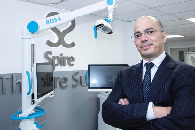 Photo: Mr Veysi Veysi, consultant orthopaedic surgeon at Spire Leeds Hospital with ROSA - a robotic surgical assistant