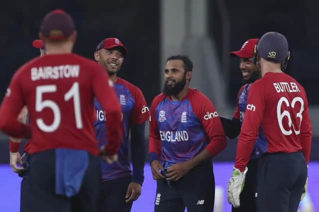 Got him: England's Adil Rashid, centre, is congratulated by team-mates after taking the wicket of West Indies' Andre Russell in Dubai. Picture: AP Photo/Aijaz Rahi