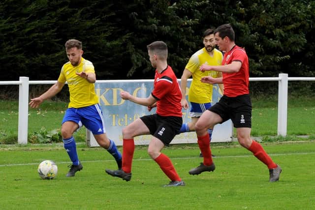 Horsforth St Margaret's Joe Fitzpatrick goes  past James Flynn of Knaresborough Town. Picture: Steve Riding.