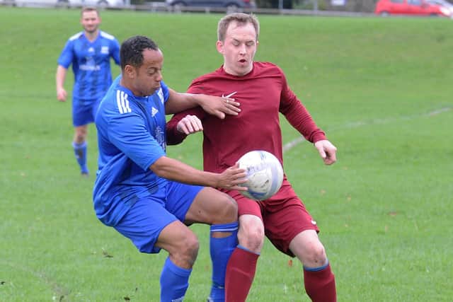 Ben Small of HT Sports and Paul Hewson of Little London challenge for the ball in the Sanford Cup on Sunday. Picture: Steve Riding.
