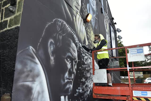 Phil Harris pictured putting the finishing touches to the mural a few weeks ago.