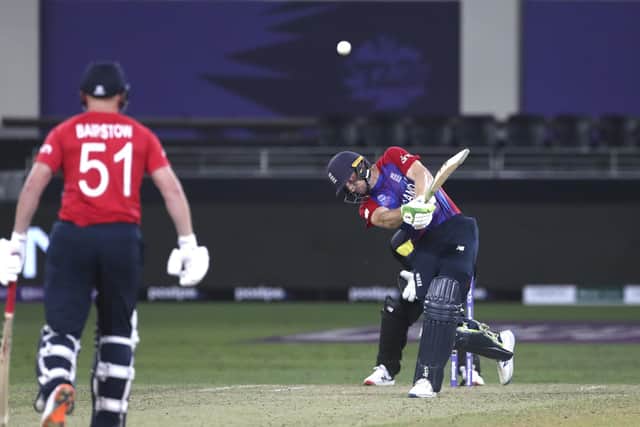 England's Jos Buttler hits a six on his way to an unbeaten 71 against Australia in Dubai. Picture: AP/Aijaz Rahi