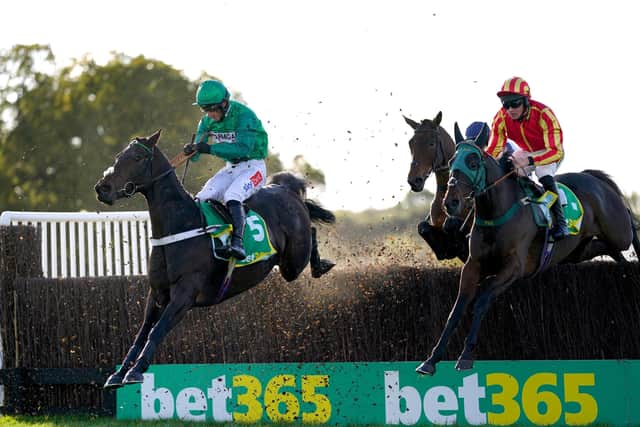 WINNING RIDE: Fusil Raffles and jockey Daryl Jacob (left) clear a hurdle on their way to winning the bet365 Charlie Hall Chase at Wetherby Picture: Tim Goode/PA