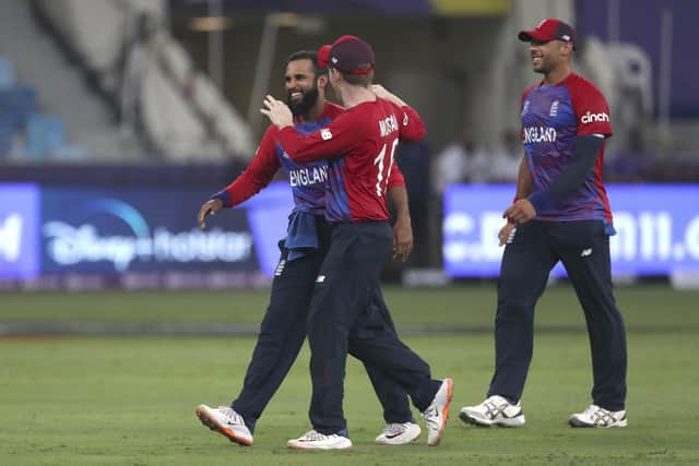 England's Adil Rashid, left, is congratulated by England's captain Eoin Morgan after taking the wicket of West Indies' Obed McCoy in Dubai last week. Picture: AP/Aijaz Rahi