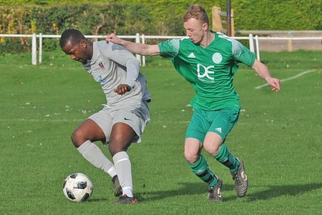 Sinmi Oyebanji, of Route One Rovers, holds off Tom Hicks during Saturday's 6-0 Yorkshire Amateur Supreme win over Mount St Marys. Picture: Steve Riding.