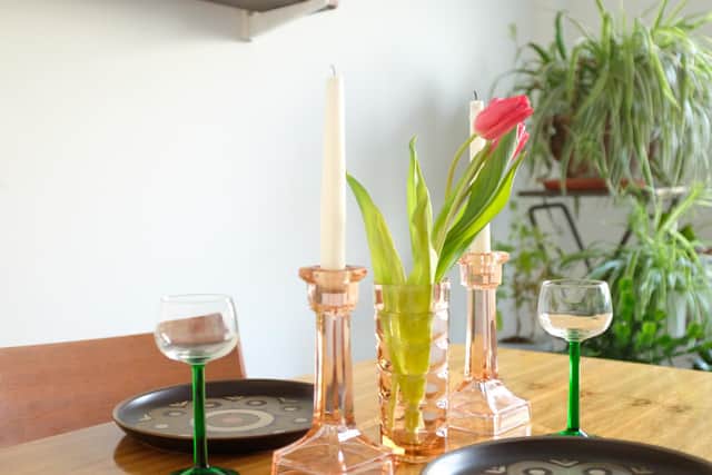 Pictured are Pink Depression glass candle sticks, 1 for both, Pink Depression glass vase for 1, and green stemmed glasses 2 for four - all from Emmaus Leeds