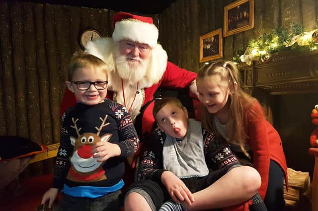 Jack Mangan with his brother Josh and sister Georgia meeting Santa Claus.