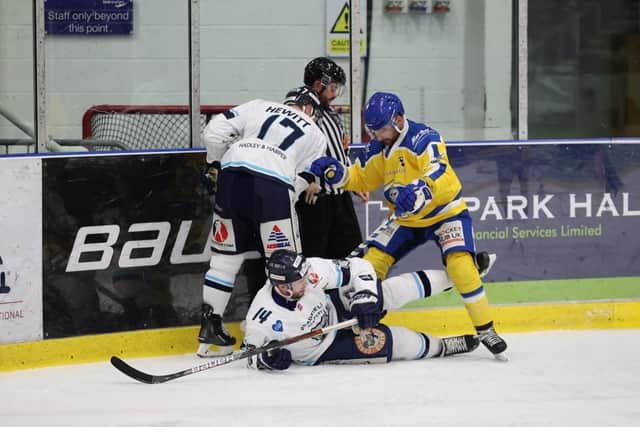 Sheffield Steeldogs' James Spurr takes a tumble as Leeds Knights' captain Sam Zajac battles on the boards with Jason Hewitt. Picture courtesy of Peter Best.
