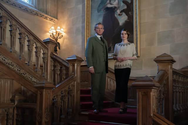 Hugh Bonneville, who stars as Robert Grantham, and Michelle Dockery, who returns as Lady Mary pictured on the stairs of the stately home. PIC: Ben Blackall/Universal/PA Wire