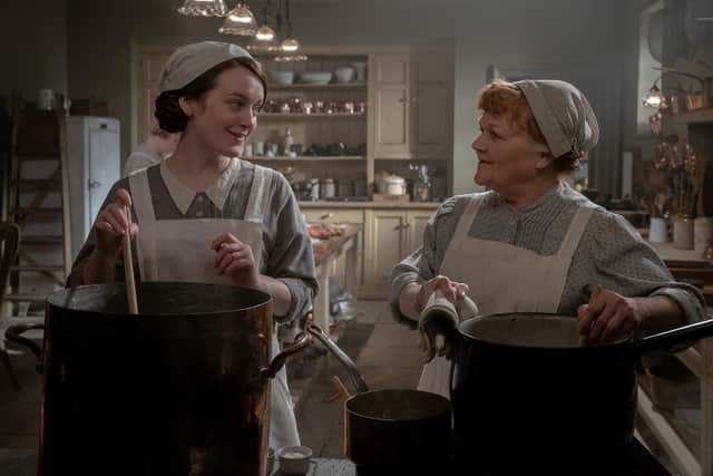Sophie McShera's Daisy and Lesley Nicol's Mrs Patmore chatting over a stove in the kitchen of the fictional Yorkshire country estate. PIC: Ben Blackall/Universal/PA Wire