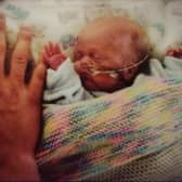 Matthew  Kandziorra pictured at two months old next to dad Dawid's hand.