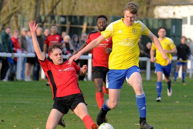 Jony Schofield of Horbury Town and Archie McDonnell of Horsforth St Margarets battle for the ball. Picture: Steve Riding.