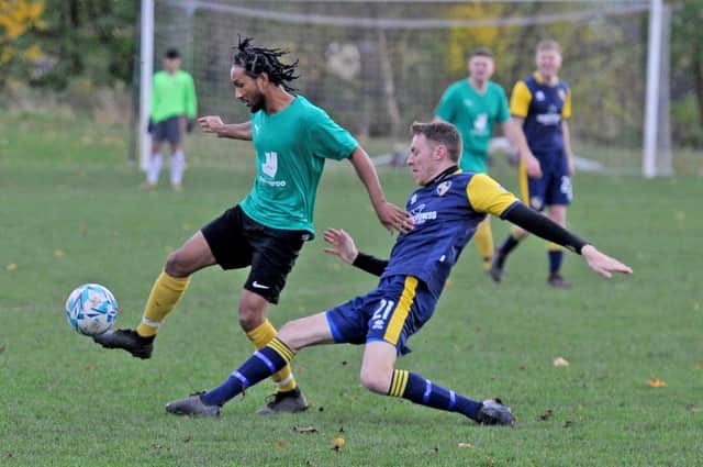 Jamil Walker, left, of North Leeds and Christian Thewlis of Dewbury Rangers challenge for the ball. Picture: Steve Riding.