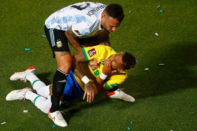 FLASHPOINT: Argentina's Nicolas Otamendi goes to pick up Leeds United's Brazil international Raphinha after catching him in the face with his elbow. Photo by Marcos Brindicci/Getty Images.