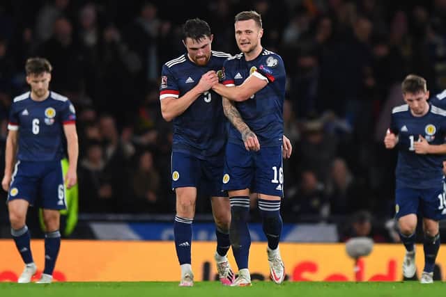 'REMARKABLE': Tony Dorigo has saluted Leeds United captain and Scotland international Liam Cooper, right, pictured with goalscorer John Souttar after netting against Denmark on Monday. Photo by ANDY BUCHANAN/AFP via Getty Images.