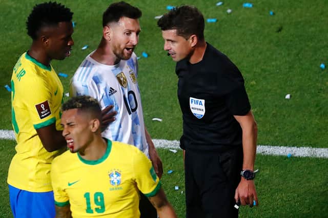 FLASH POINT - Leeds United's Raphinha was caught in the mouth with an elbow but match officials in Brazil's game against Argentina did not believe the incident warranted a red card. Lionel Messi is seen in conversation with referee Andrés Cunha. Pic: Getty